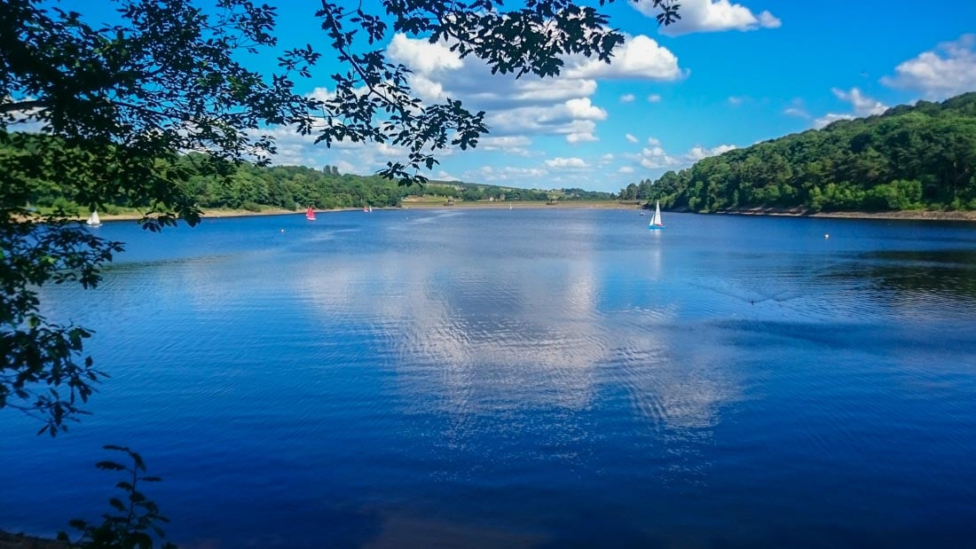 damflask reservoir in the sun and a boat