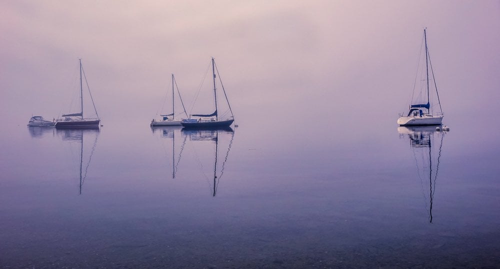 reflections of boats on a mere