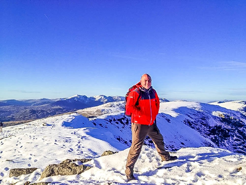 paul steele on the summit of coniston old man in winter