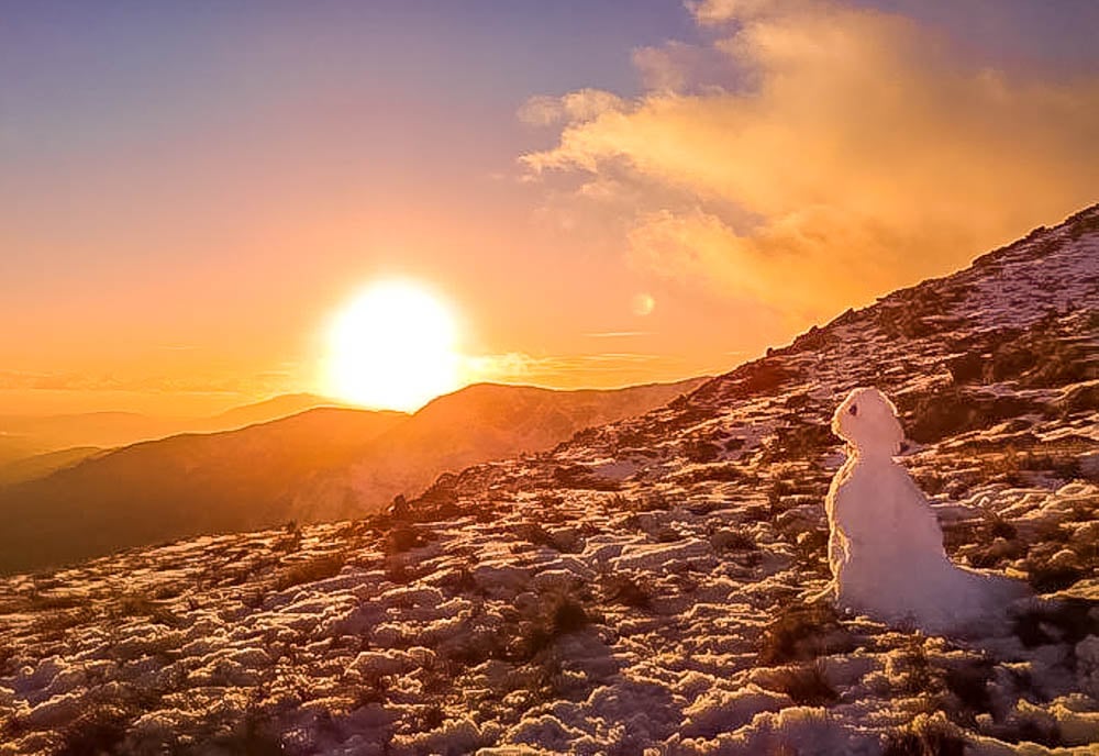 sunset and snowman on coniston old man